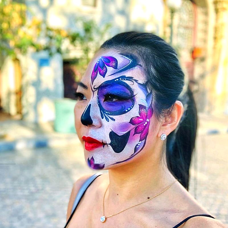 woman with half of her face artistically painted