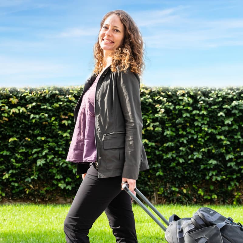 photo of a woman holding a luggage